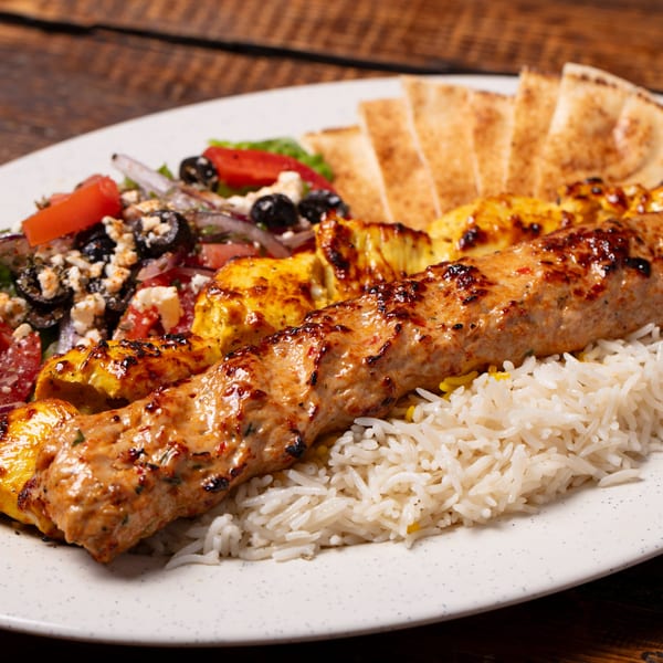 Oliver Pepper's Mediterranean platter with grilled chicken and kofta kebabs, rice, Greek salad, and pita bread.